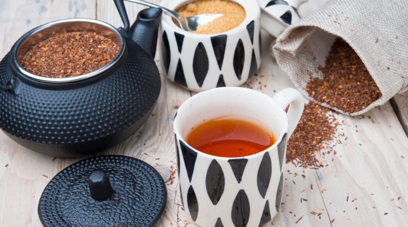 A mug of tea and a kettle steeping